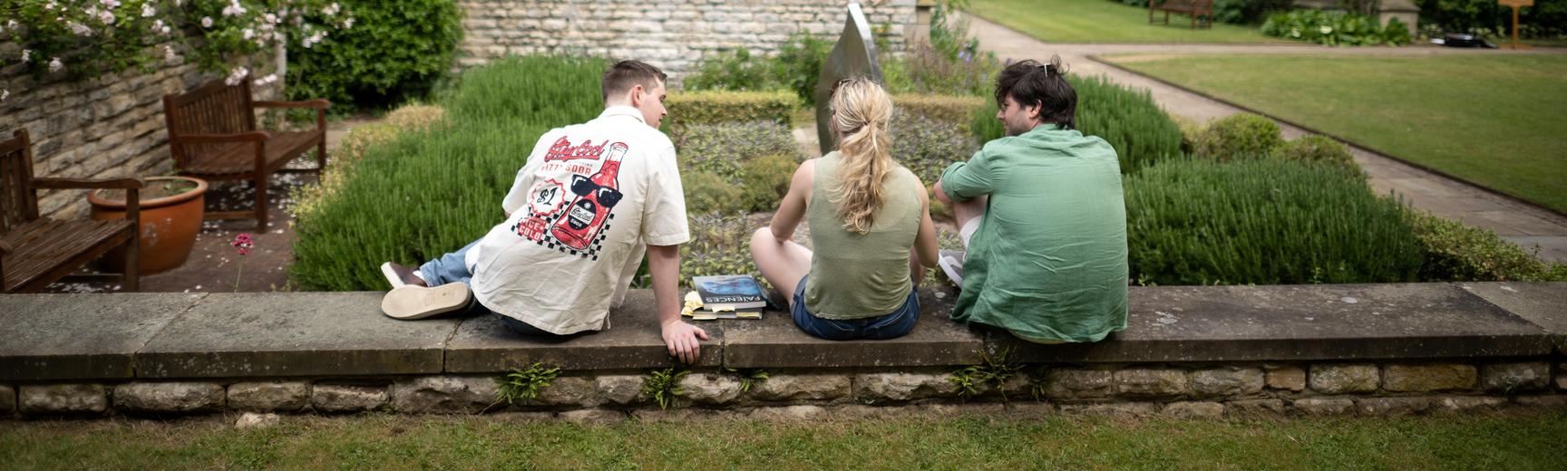 Three students in the grounds of an Oxford college