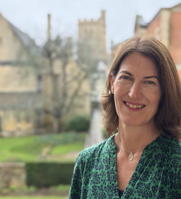 Professor Beth Breeze with background of Harris Manchester College
