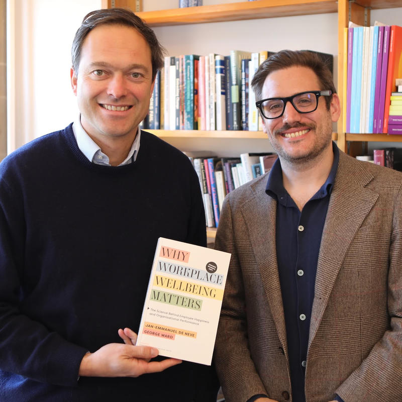 Professor de Neve and Dr Ward holding their book