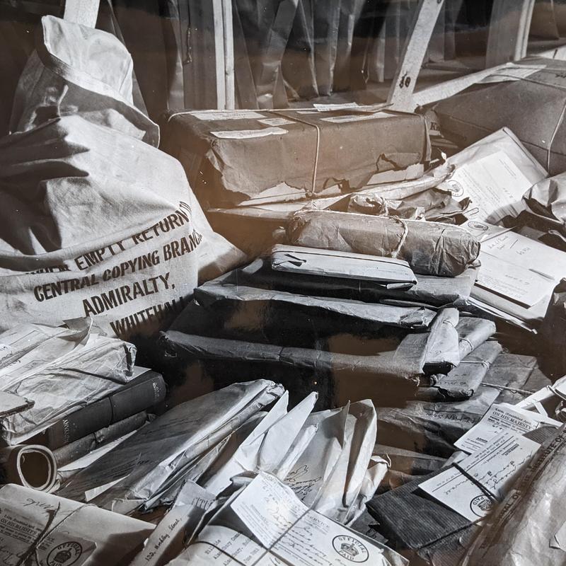 Bags of postcards Black and white photograph of piles of parcels and bags containing letters all crowded together