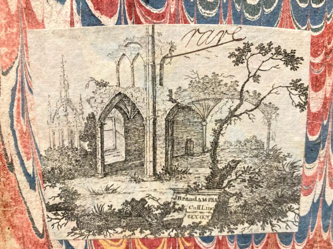 An etched image of a landscape scene with ruins