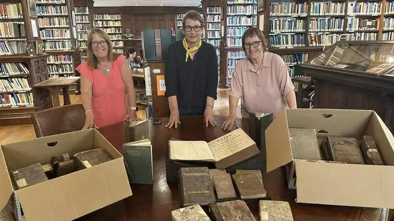 College Librarian Kate Alderson-Smith (centre) with Nans Davies and her sister, Mair Potter, in the Tate Library with the newly acquired books.