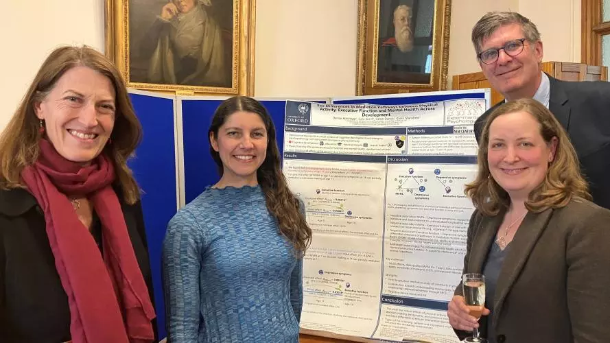 Denise Kohlepp in front of her poster with Beth Breeze, Rob Klassen and Bethany Sollereder