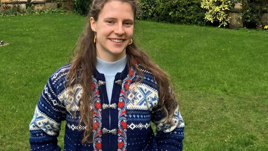 An image of a young woman in a college garden
