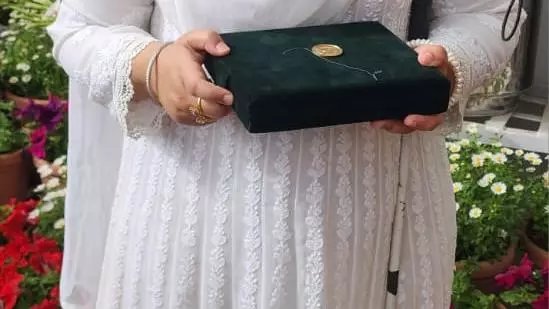 Student Khansa Maria with her Medal of Excellence