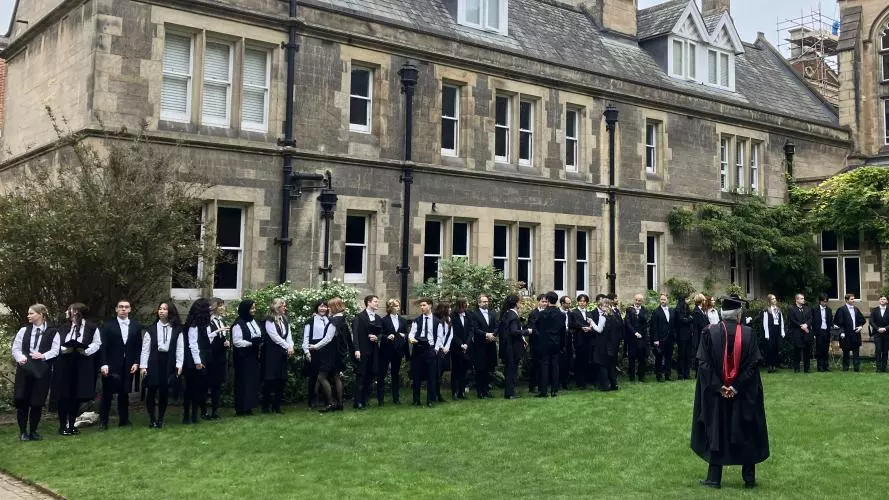 Students in gowns in a college quad