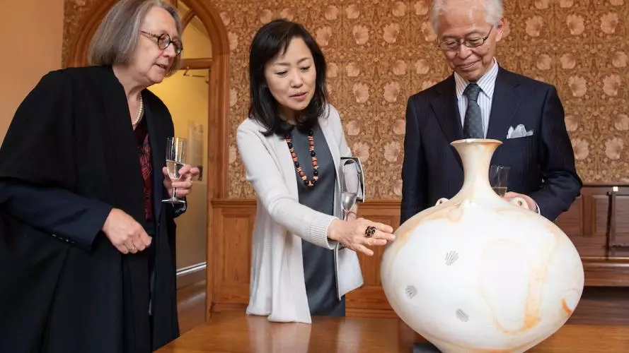 Ambassador and Madamme Hayashi with the Principal admiring Peter Sparrey's stoneware pot.  