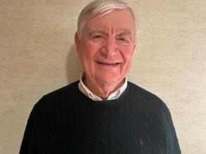Headshot of a man in a green sweater