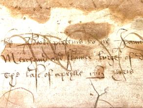 A detail of a handwritten inscription in elaborate hand 