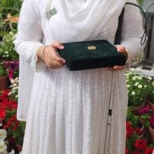 Student Khansa Maria with her Medal of Excellence