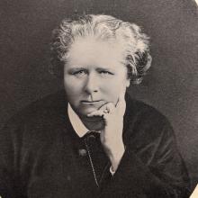 Black and white photograph of a female.  Head and shoulders. 