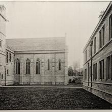 A black and white photograph of the Tate Quad with the stonework looking very bright and new.  There are no plants and the lawns look just laid.