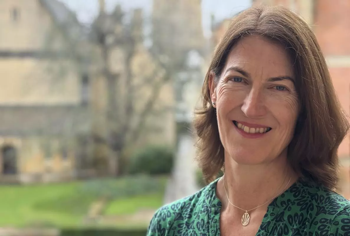 Professor Beth Breeze with background of Harris Manchester College