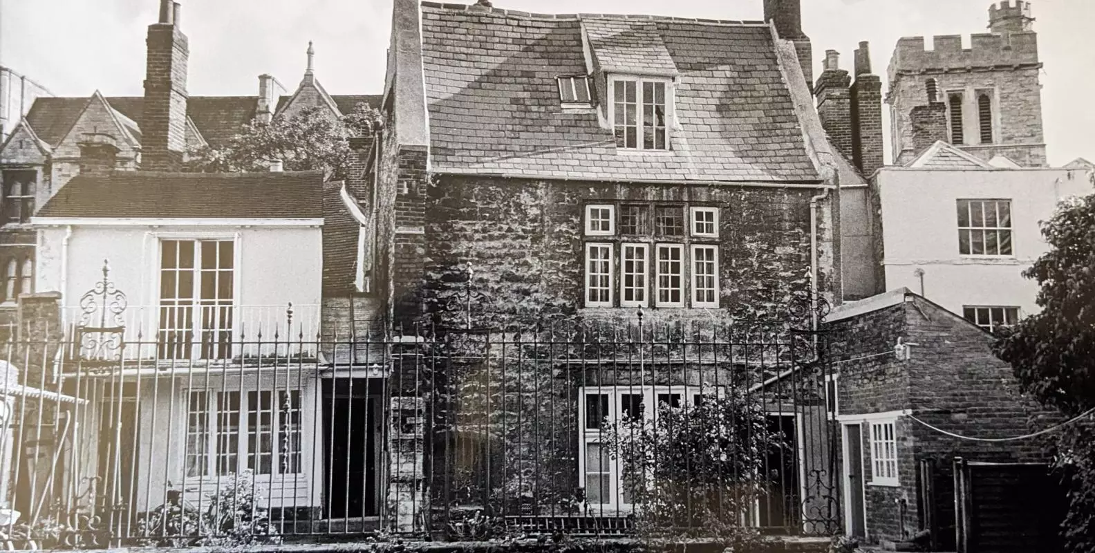 A black and white photograph of two buildings of two storeys close together