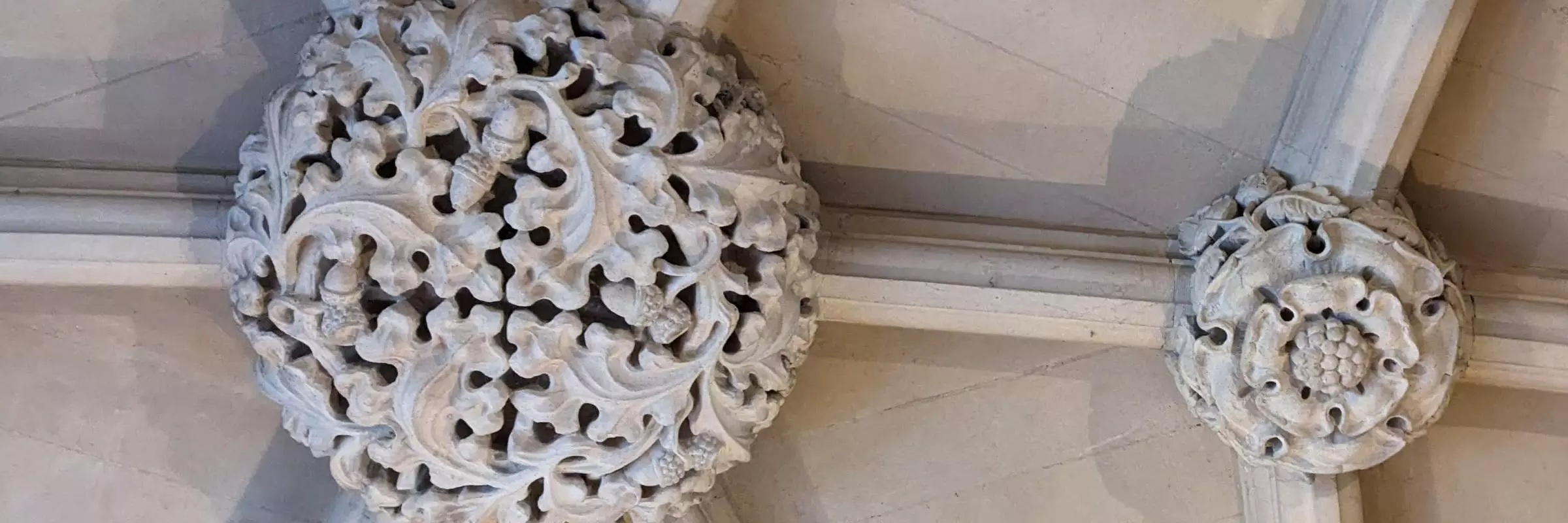 Two decorated ceiling bosses, one based on oak leaves and acorns and the other with the Lancaster rose.