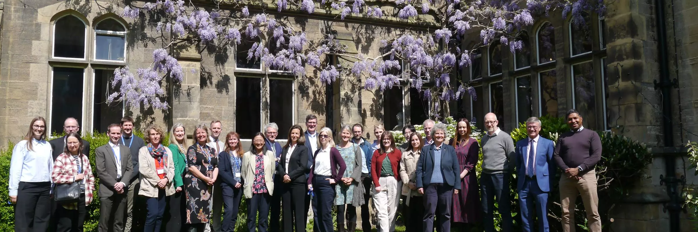 Doctors and teachers roundtable group photo in college quad