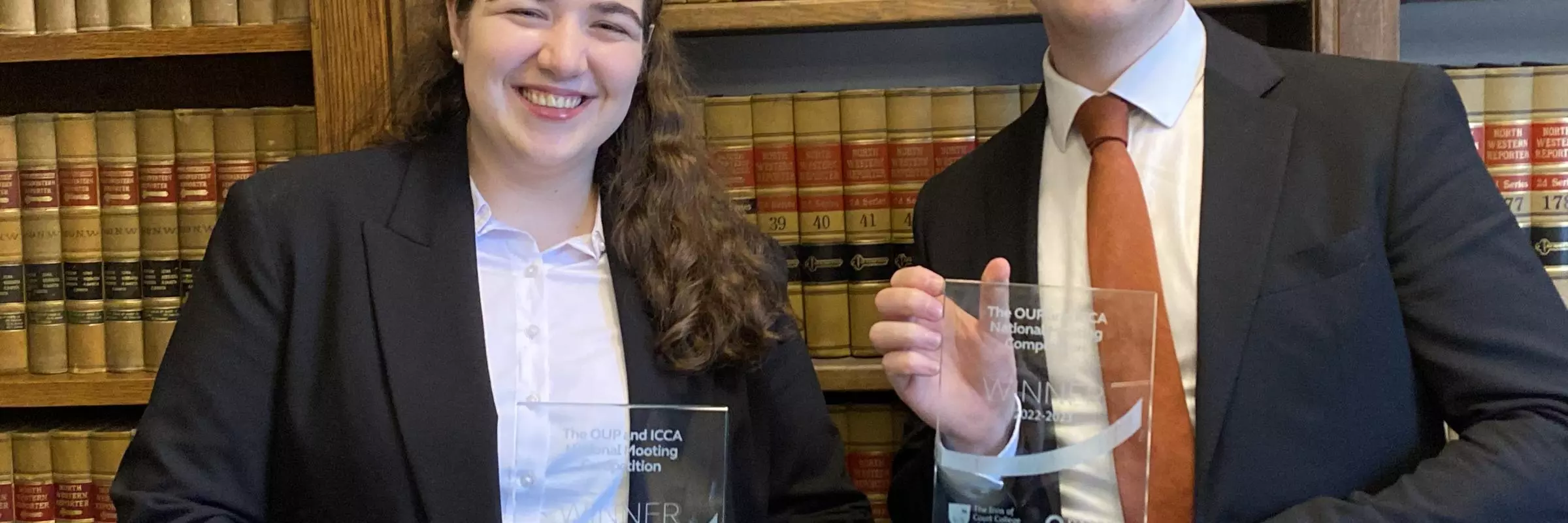 Man and woman holding trophy