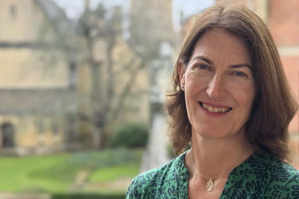 Professor Beth Breeze with background of Harris Manchester College